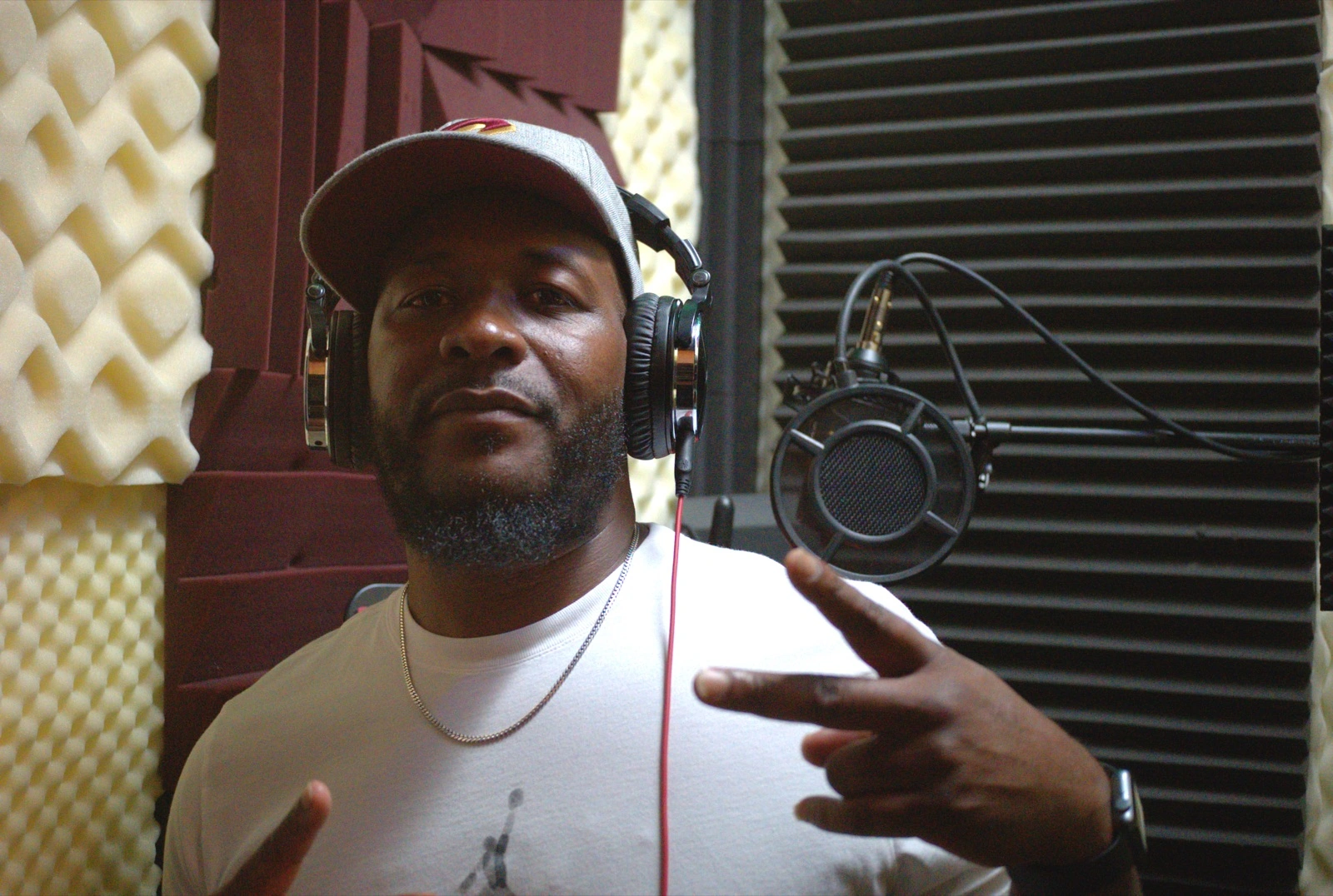 Jjune recording vocals in the booth at Checkmark Audio