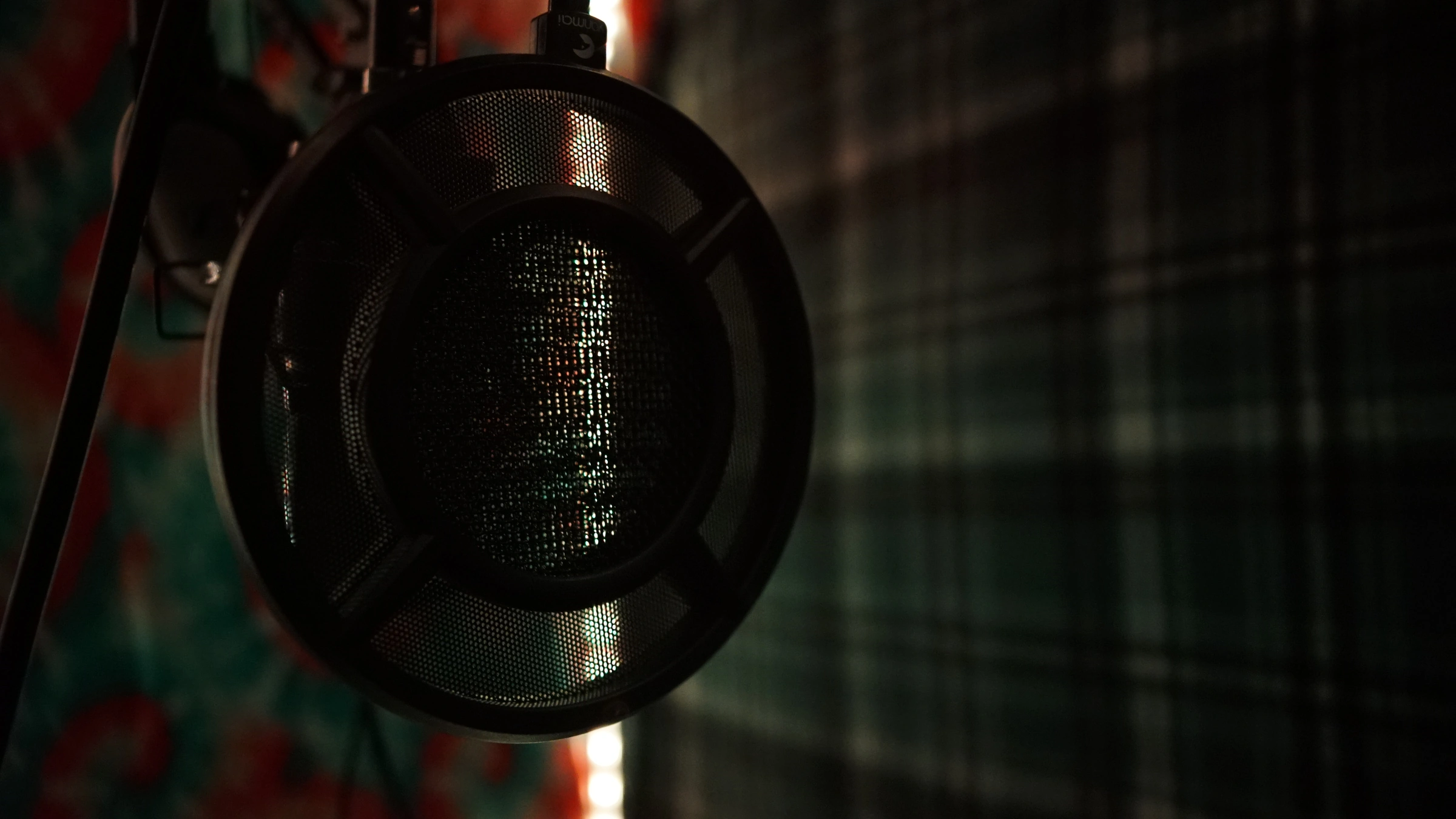 Studio B microphone under warm golden booth lighting