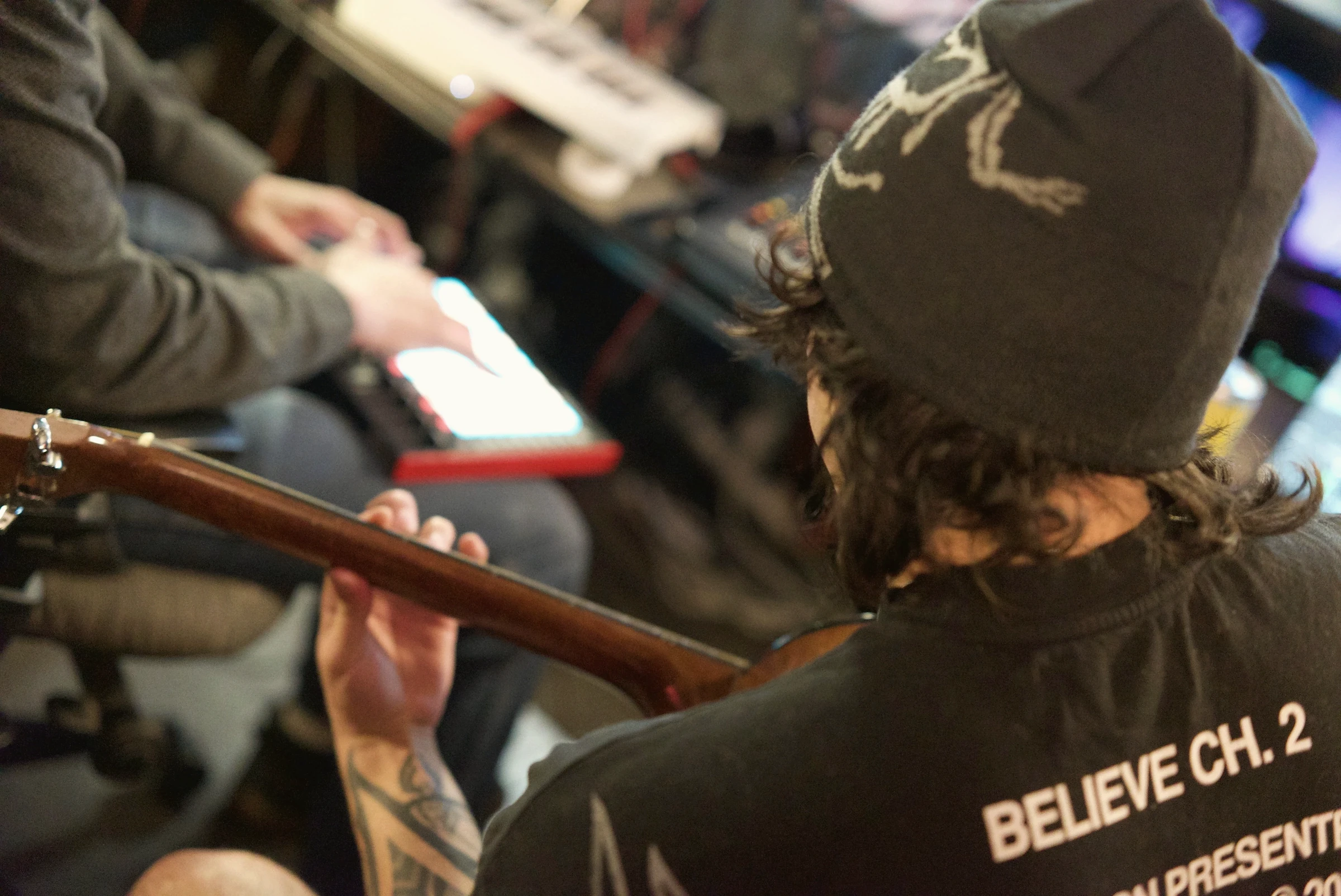 Artist playing guitar during a Checkmark Audio recording session